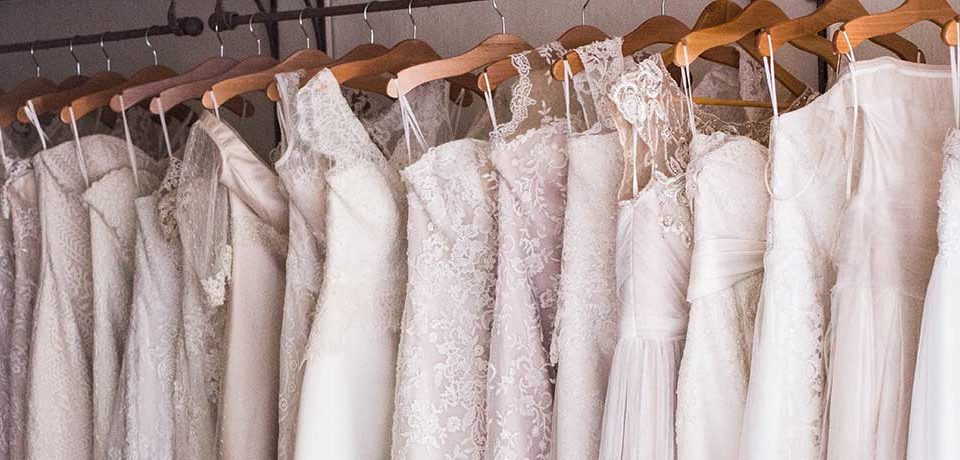 Bridal shop with bridal dresses on a rail.